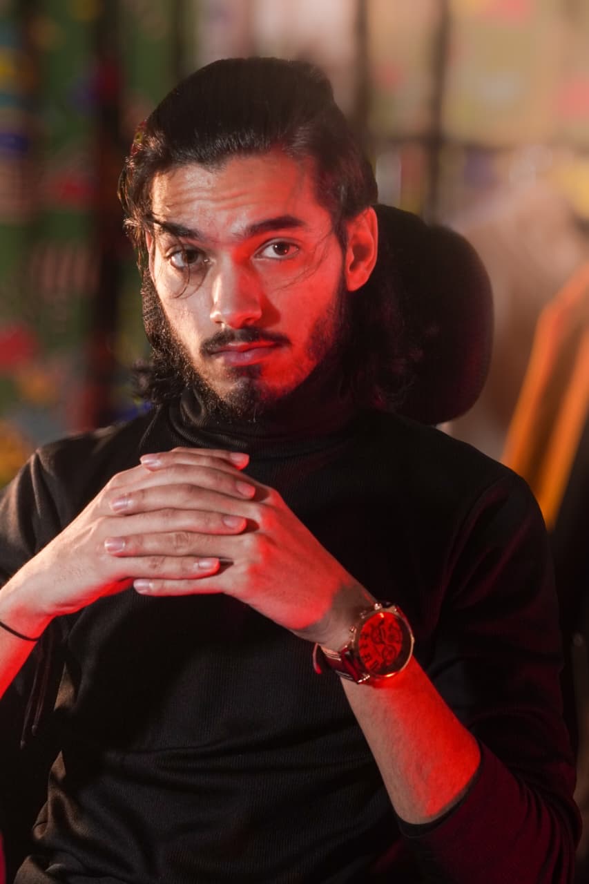 Founder of Qalakari in a neon-lit studio